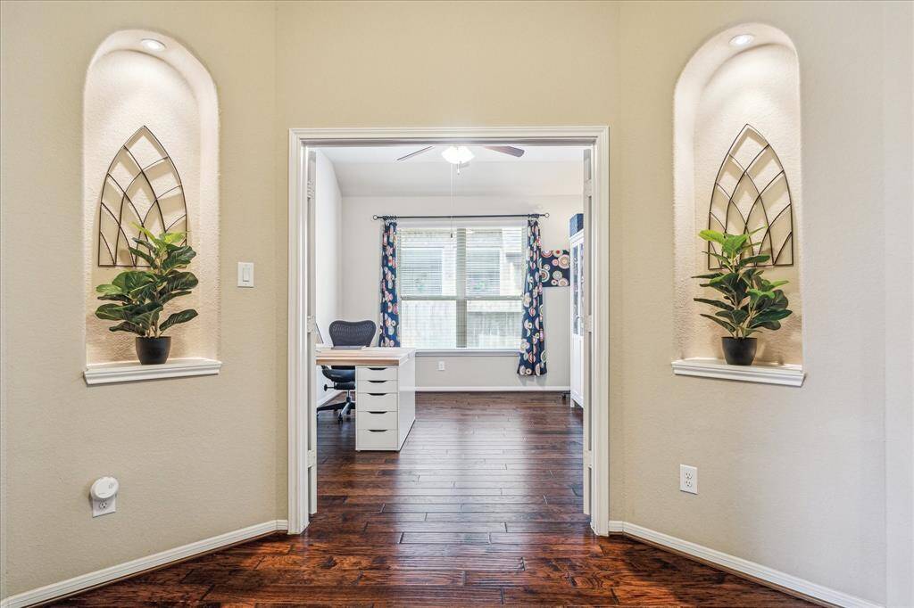 Elegant, lighted art niches frame the study, creating a beautiful showcase for your favorite pieces and adding a refined touch to the space.