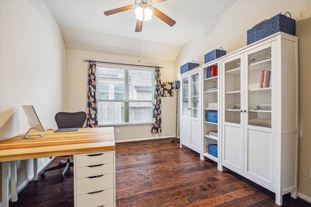 You’re going to love the morning commute to this spacious private home office. Tucked behind double doors, it features beautiful wood flooring, a raised ceiling with a cooling fan, large windows, and plenty of space for all your work-from-home essentials.