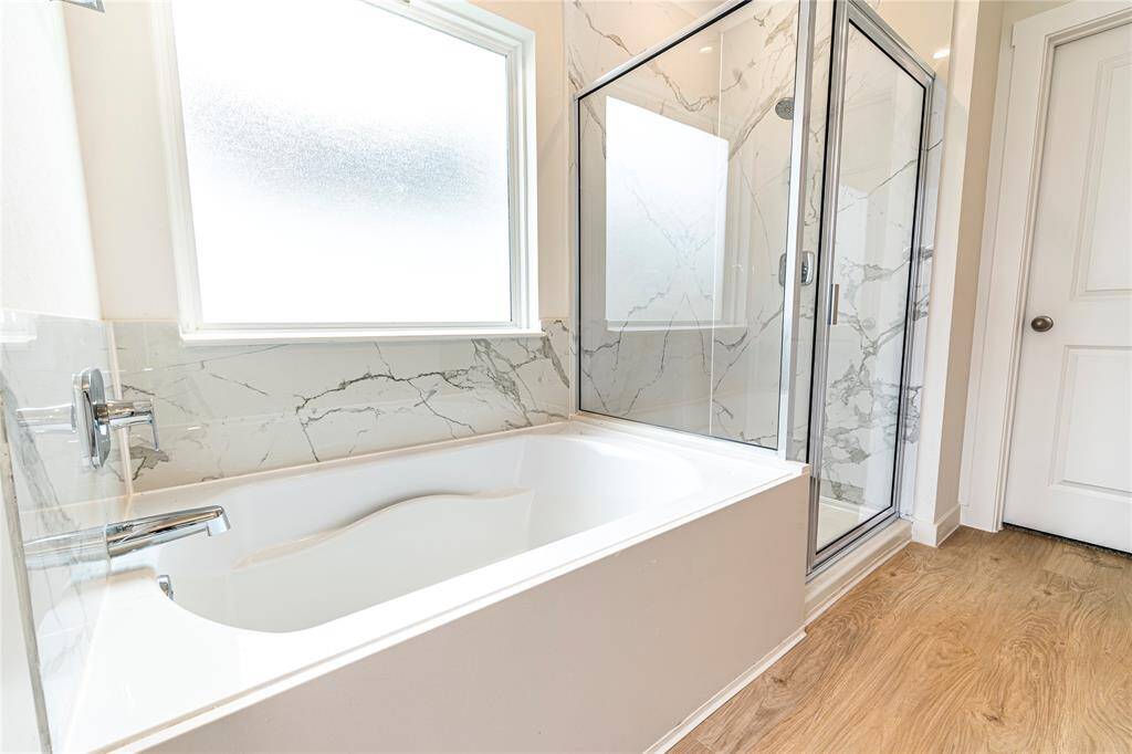 Master bath with a soaking tub and walk-in shower.