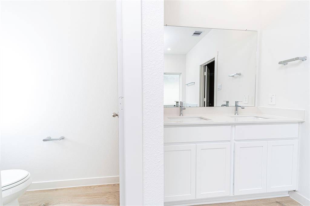 Separate toilet and double vanity.