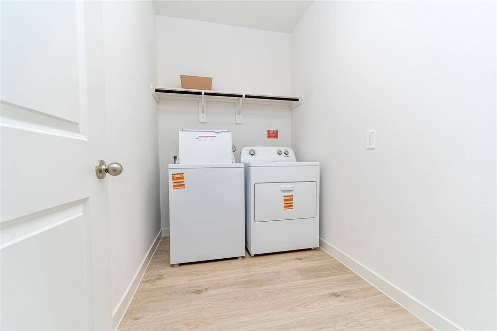 Laundry room downstairs with washer and dryer.