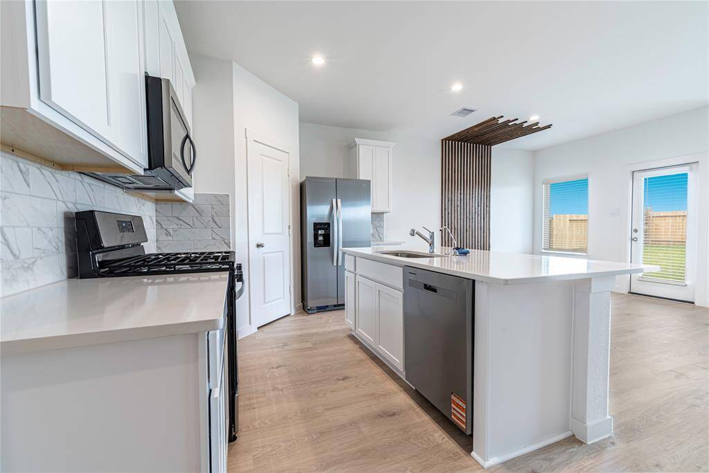 Spacious kitchen with a walk-in pantry for ample storage.