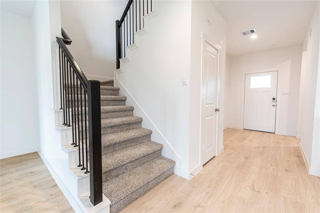 Staircase with metal railing enhances the look and feel of spaciousness.