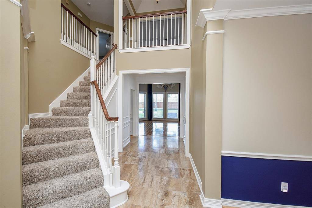 The impressive entry boasts of a curved staircase to the second floor. The seller installed picture molding in entry to hallway and hallway leading to master bedroom. Replaced 2-ton air conditioning unit for upstairs comfort.