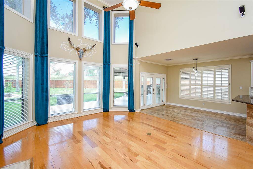 The spacious living area has soaring ceilings with large windows to fill the room with natural light! Enjoy built-in surround sound! Seller replaced 4-ton 16 seer air conditioning unit for downstairs comfort.