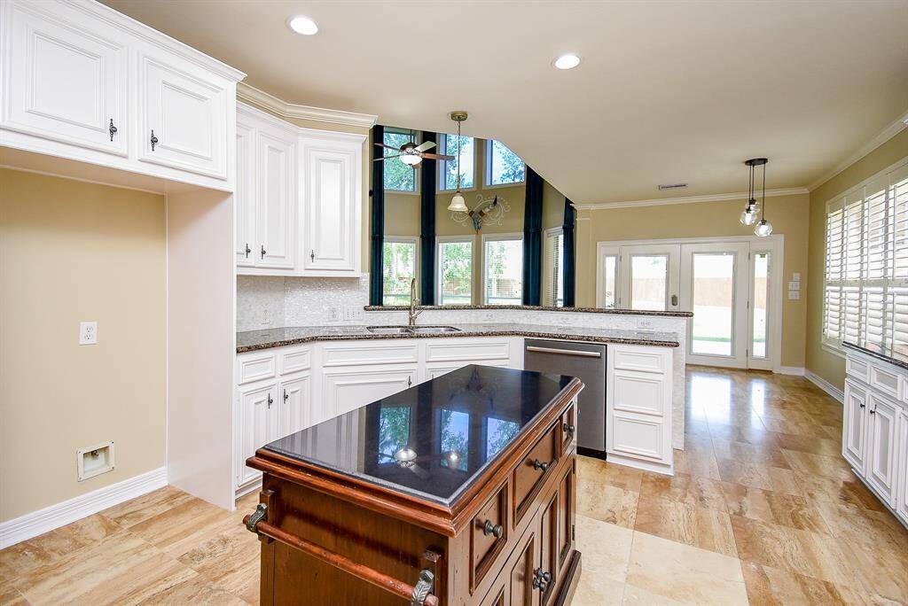 This dream kitchen offers plenty of storage, extra drawer storage and a glass tile backsplash that can be removed to expose the travertine backsplash if preferred.