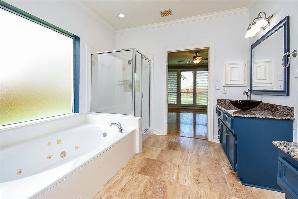 Relax in the whirlpool tub! Separate shower and travertine floors! Installed GFCI protected electrical outlets in powder room and master bedroom toilet closets for bidet installation.