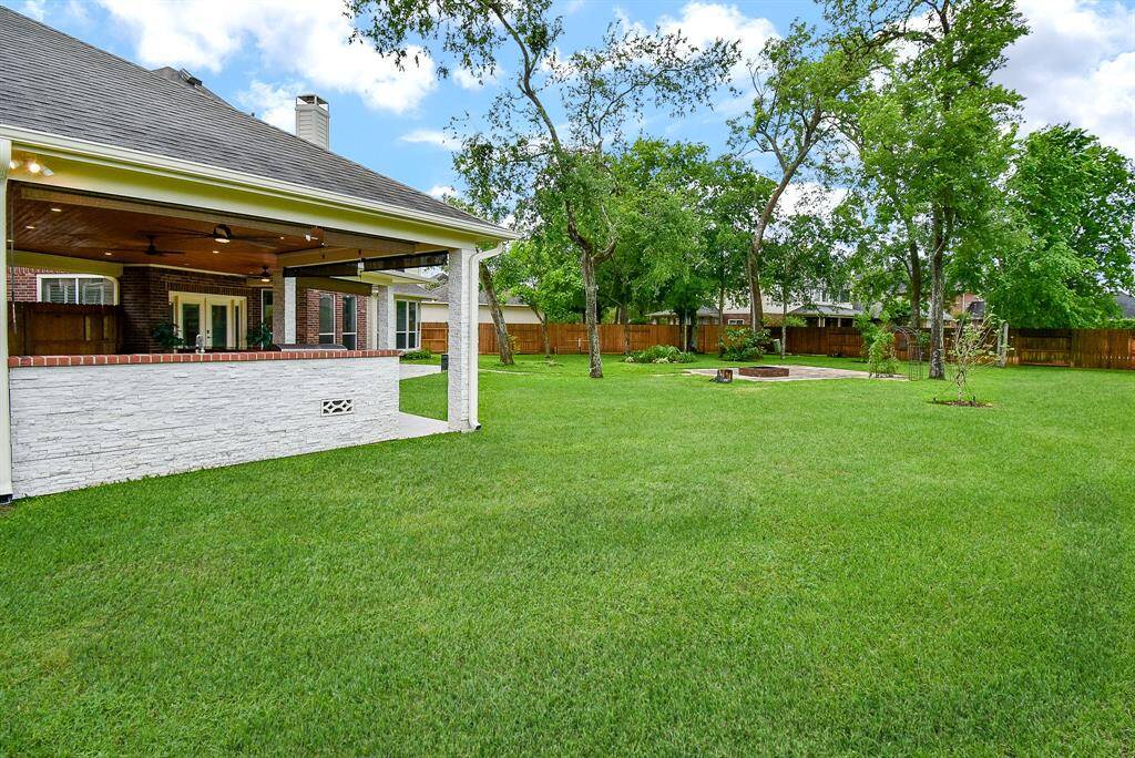 Seller even covered back of outdoor kitchen with stacked stone! Great attention to detail! Installed gutters with leaf-guard like screens around entire house. The seller installed gate access to walking trail behind home!