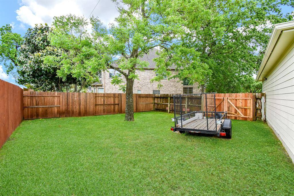 Large side yard next to garage with double wide gated entry!