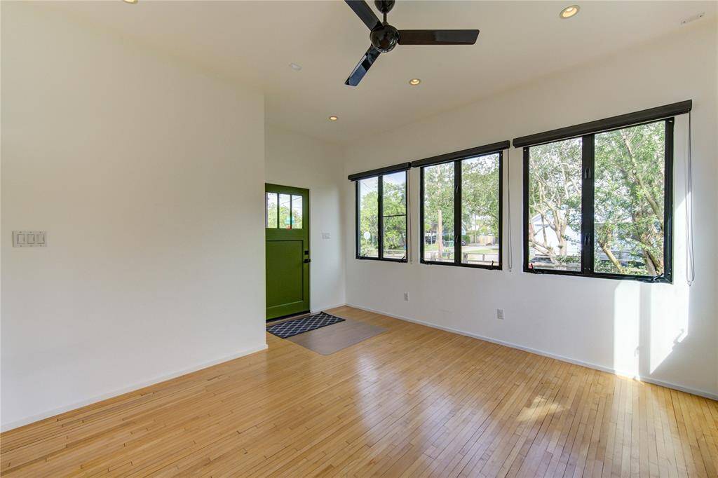 This versatile space, formerly a formal living room, is now ideal for a home office or cozy den, featuring individual climate control for personalized comfort.
