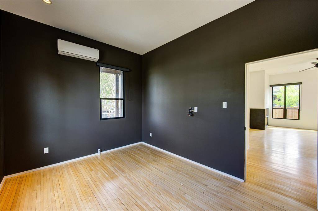 This versatile downstairs room, previously used as a second home office, offers the potential to be a guest bedroom with the addition of a closet. Enjoy individual climate control for personalized comfort.