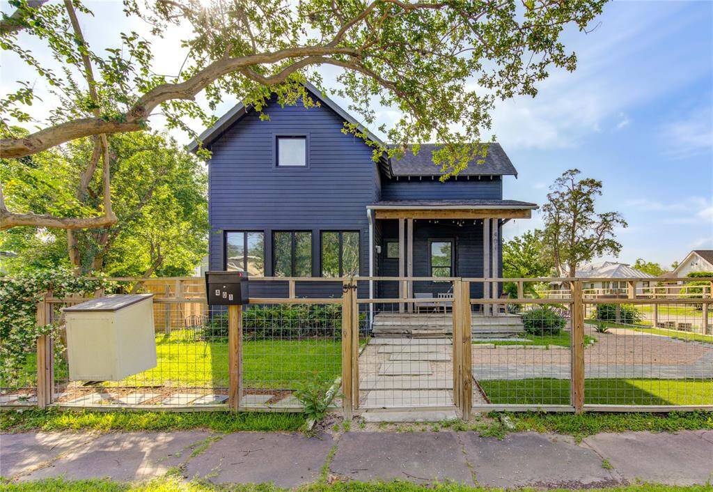 Charming covered porch and low-maintenance dog run, thoughtfully staged for your convenience.