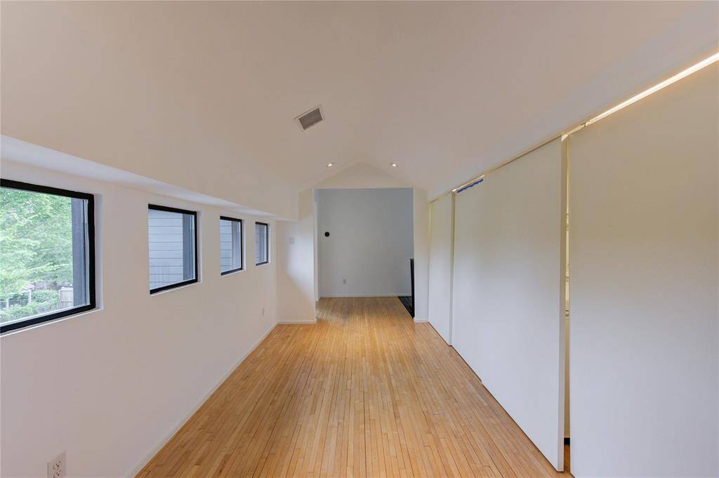 The washer and dryer are neatly hidden behind sleek sliding doors.