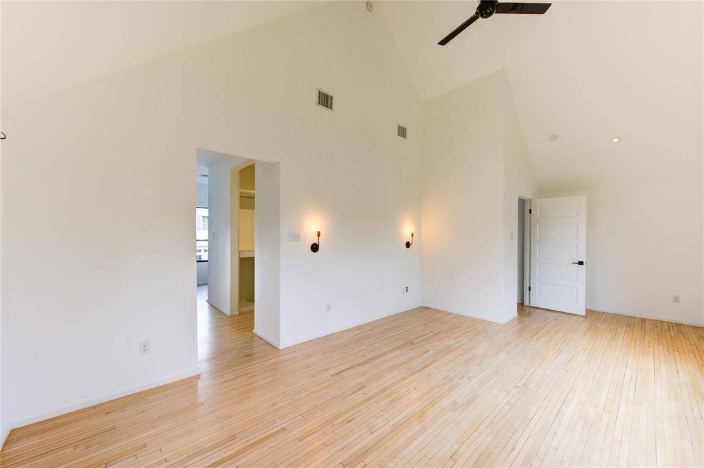 Bedroom has high soaring ceilings, and abundant natural light.