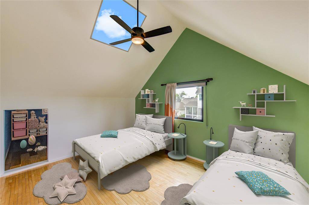 Discover this delightful children's bedroom with vaulted ceilings, a cozy play area, and a skylight that bathes the space in natural light, offering  downtown views. Virtually staged.