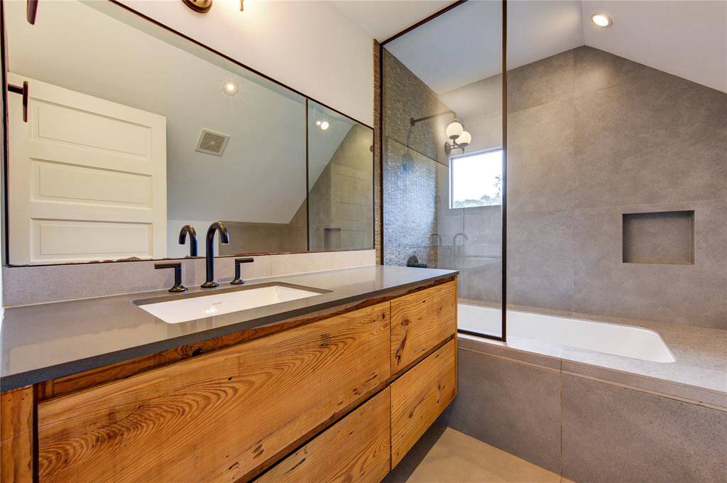 Custom shower/tub combo on the second floor, beautifully blending original charm with modern updates.
