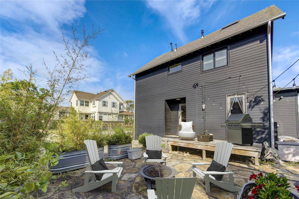 Expansive patio perfect for entertaining and added garden beds with lush bamboo for added coziness. (Virtually staged)