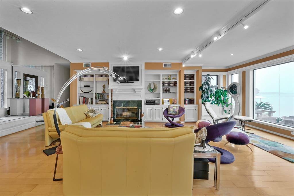 Built in shelving and wood burning fireplace in the living area
