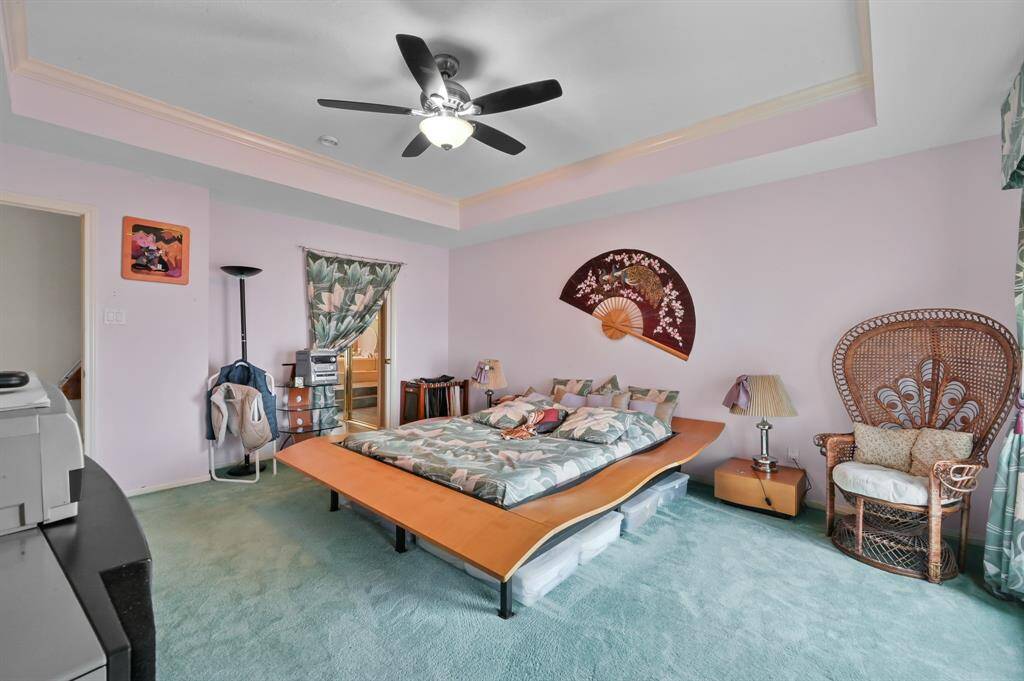 Recessed lighting with crown molding in the primary bedroom
