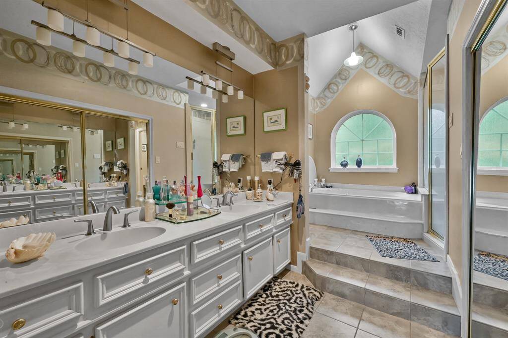 Primary bath with jetted garden tub and separate shower, double vanities