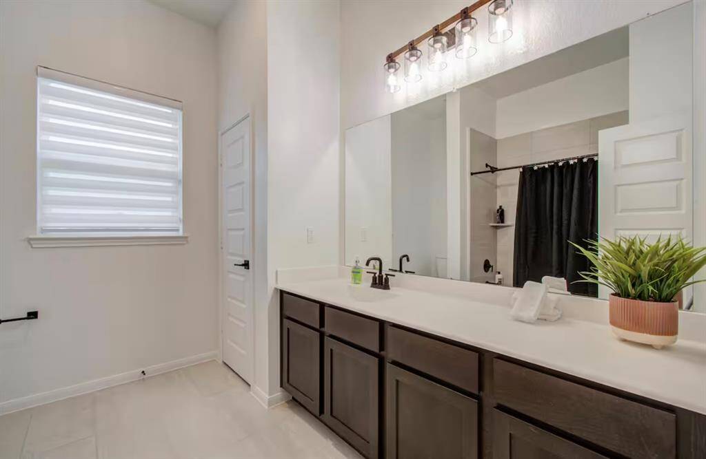 Secondary bathroom features atub/shower combo and long vanitywith plenty of counter space.