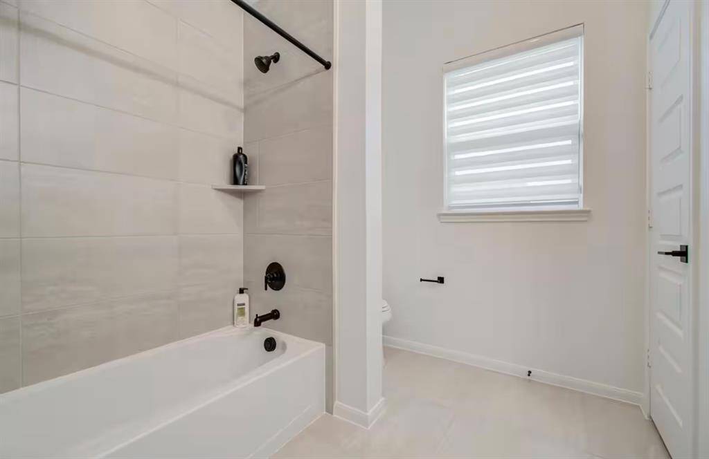 Third bathroom features atub/shower combo with tile surround.