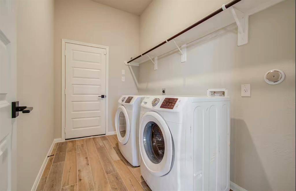 The laundry room features beautiful floors,washer and dryer connections, andplenty of storage space.