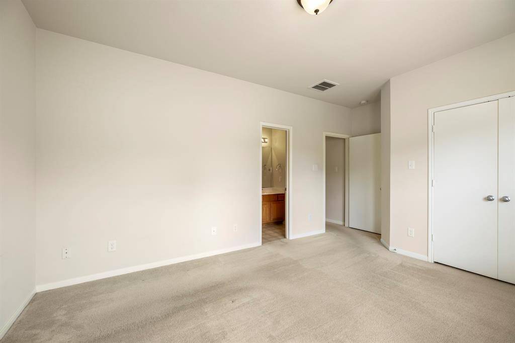 Looking back toward the entrance of the primary bedroom, you'll notice double doors leading to a spacious closet, offering ample storage. A private entrance to the home's single bathroom adds convenience and privacy, making this bedroom a comfortable and functional retreat.