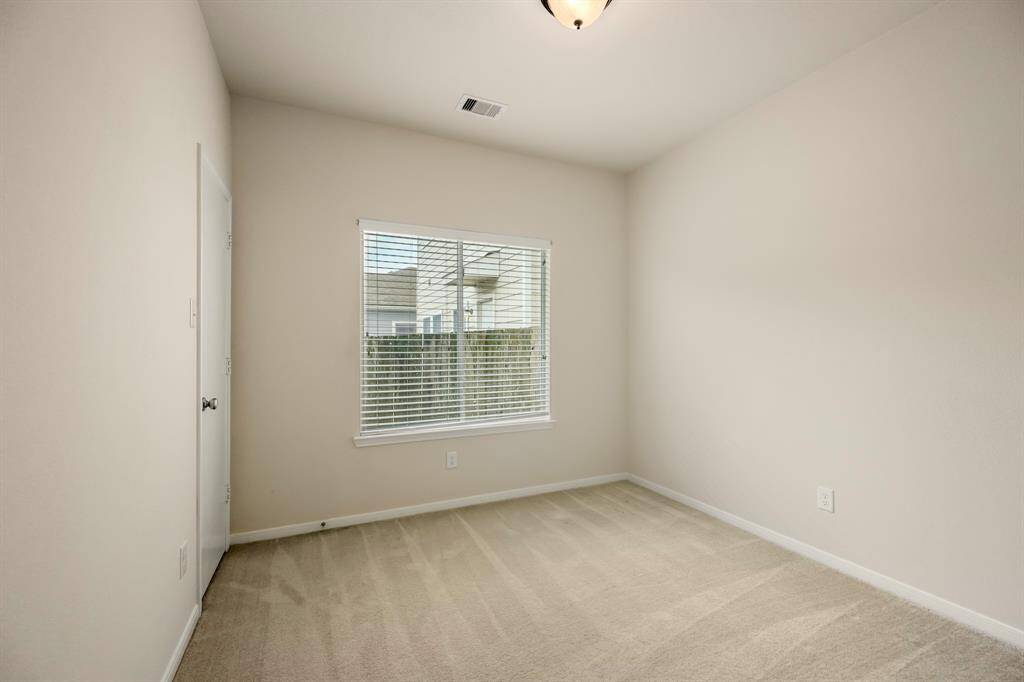 The second bedroom offers a surprisingly spacious walk-in closet, providing ample storage space for all your belongings. This room is a great option for a guest room, office, or whatever suits your needs, with the added benefit of a large, organized closet.