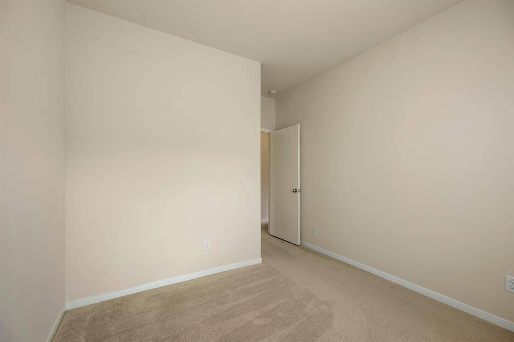 Another view of the second bedroom highlights its versatile layout, offering plenty of space for a variety of uses. The room is filled with natural light, creating a bright and inviting atmosphere, perfect for personalizing to fit your needs.