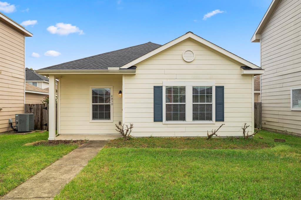 Another front view of the home showcases its inviting curb appeal, with the charming front porch and shutters on the windows adding character. The well-maintained exterior and gutters provide both aesthetic and practical benefits, making it a welcoming space from every angle.