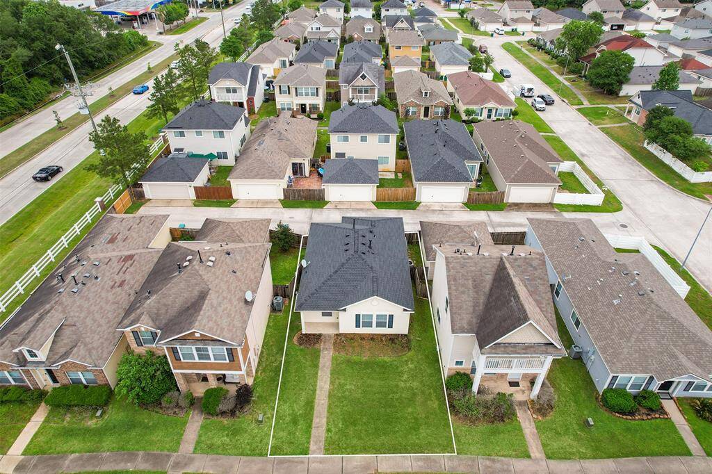 This aerial view highlights the estimated lot lines, providing a clearer perspective of the property's boundaries. It offers a helpful look at the home's location within the neighborhood, showing the surrounding space and layout.