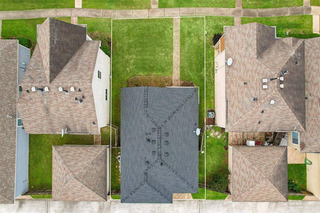 A bird's-eye aerial view of the home gives you a great perspective on the beautiful roof, which was recently installed in July 2024. This update not only adds to the home's curb appeal but also provides peace of mind for years to come.
