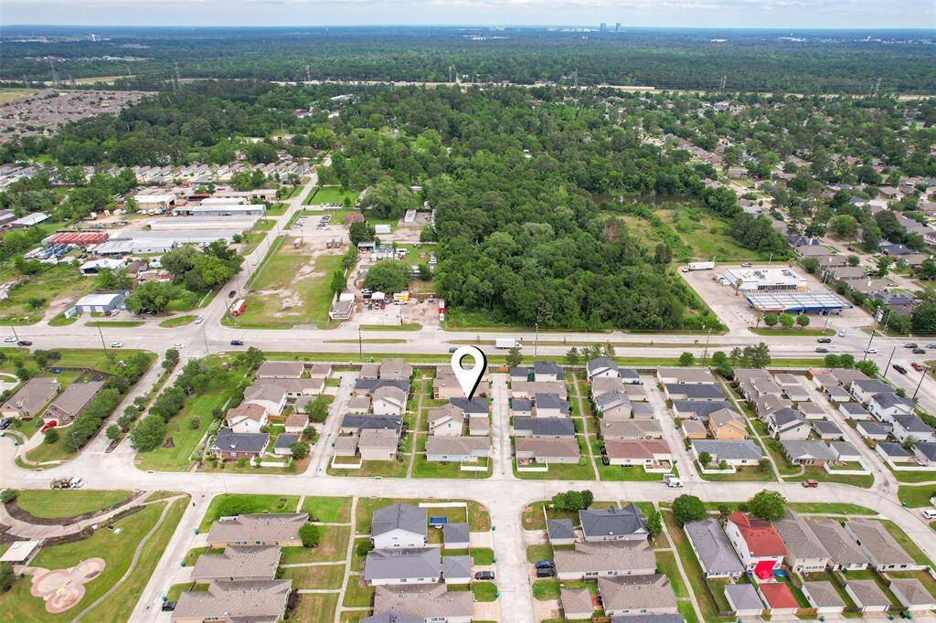This aerial perspective offers a wider view of the home's location within the neighborhood, showing how it fits into the surrounding community. You can see the layout of the area beyond, giving you a clear sense of the neighborhood's structure and its welcoming atmosphere.