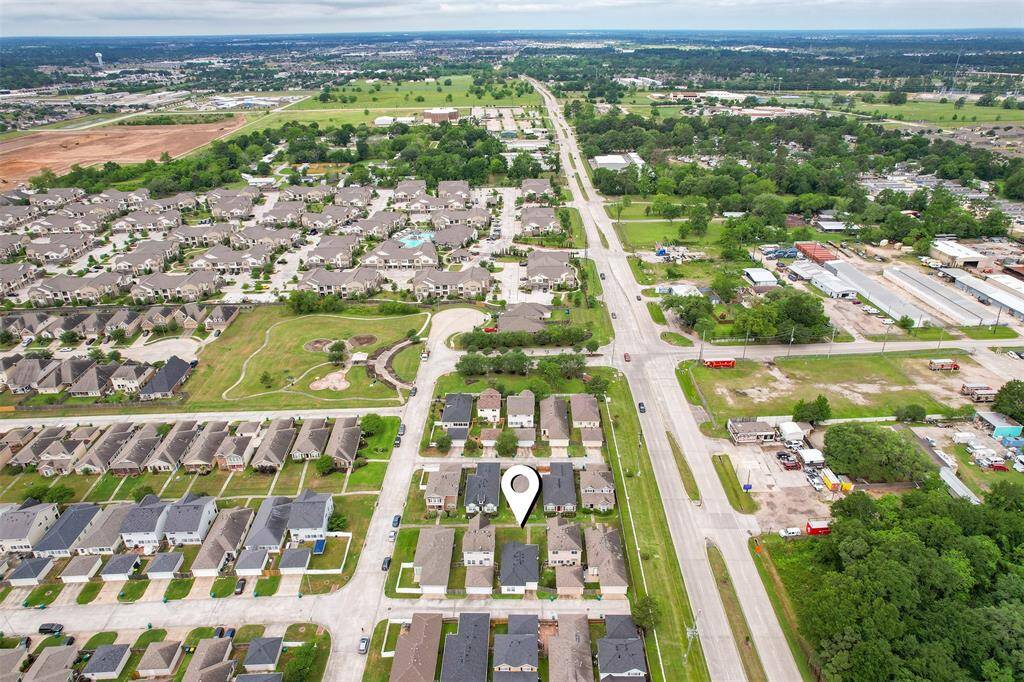 This aerial view offers another perspective of the home's location within the neighborhood, with the community park just around the corner. The nearby park provides convenient access to green space, adding to the appeal of this home's location within a vibrant, active community.