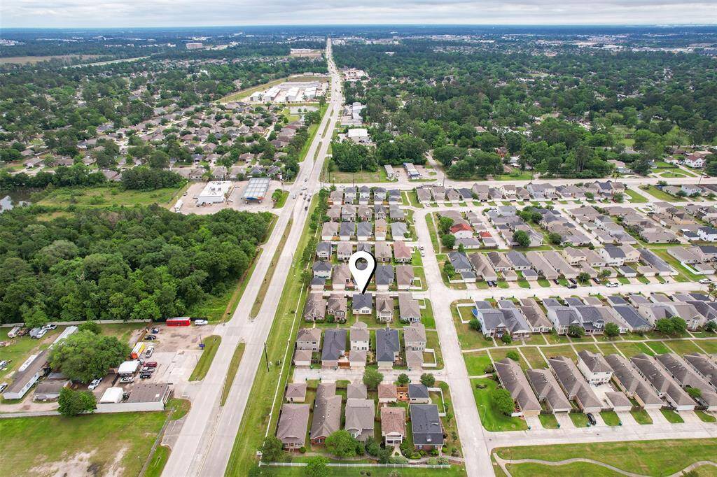 Another aerial view of the community and beyond offers a great perspective on the neighborhood’s amenities and the surrounding area. The open space and nearby conveniences create a welcoming and practical setting for this home.