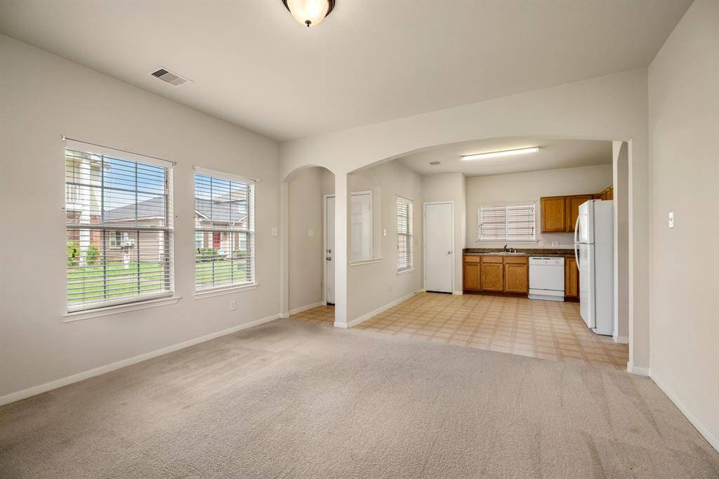 From this angle, you can see the seamless connection between the living room and kitchen. The open layout creates a spacious, airy feel, perfect for everyday living and entertaining. The natural light continues to flow through, enhancing the inviting atmosphere of the home.