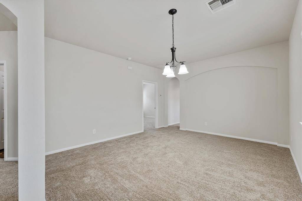 Formal dining room with easy kitchen access. Would also make a great play room!