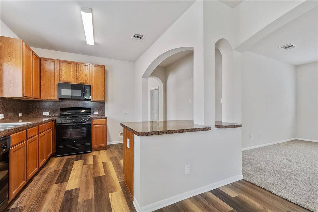 Kitchen is also equipped with an island, and overlooks the living room.