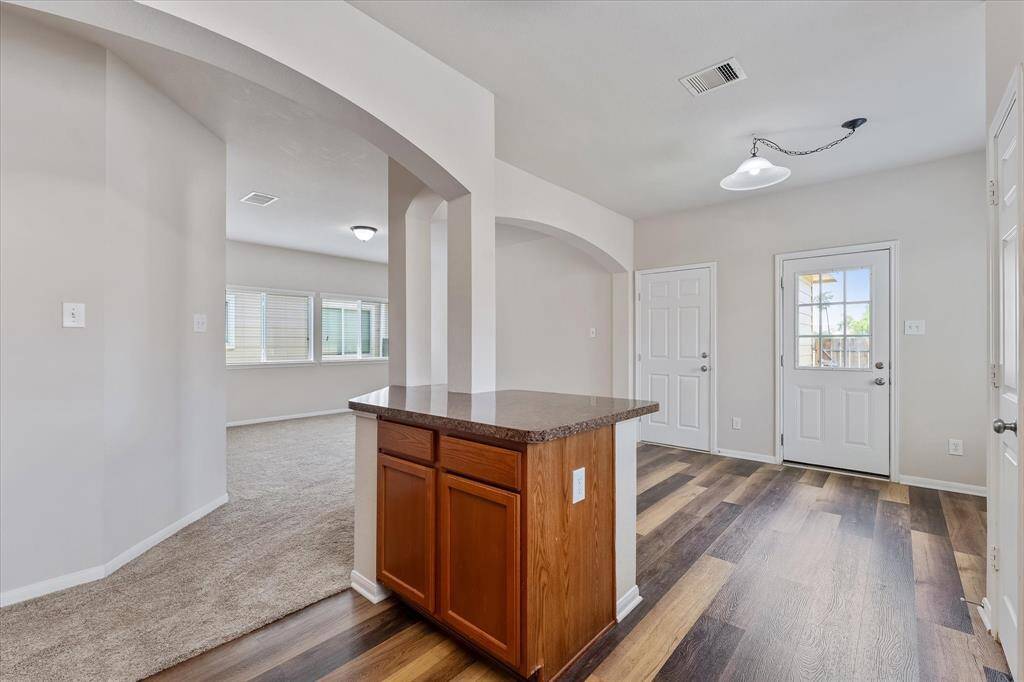 Breakfast area to the right, living room to the left. Kitchen island even has storage.