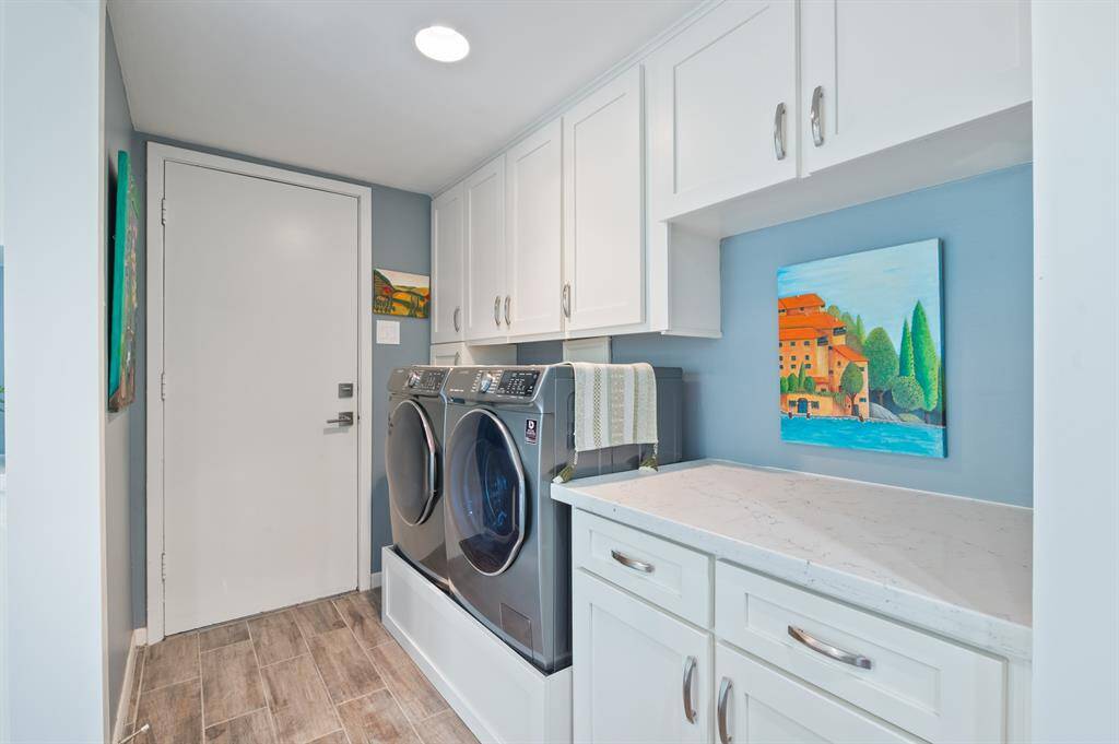 The laundry area features a convenient folding counter, offering a practical space for sorting and folding clothes. It’s designed for efficiency, making laundry day a breeze.