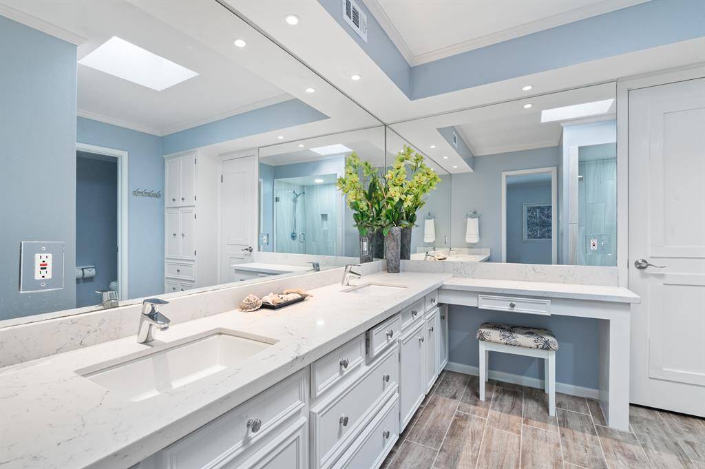 The ensuite bathroom features dual sinks and a vanity area for added convenience. A spa-like shower with a seat, along with a water closet and spacious walk-in closet, complete this luxurious retreat.