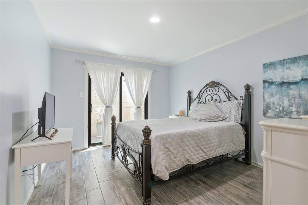 The secondary bedroom offers direct access to the back patio, creating a seamless indoor-outdoor connection. It also features a spacious walk-in closet and in-room access to the secondary bathroom.