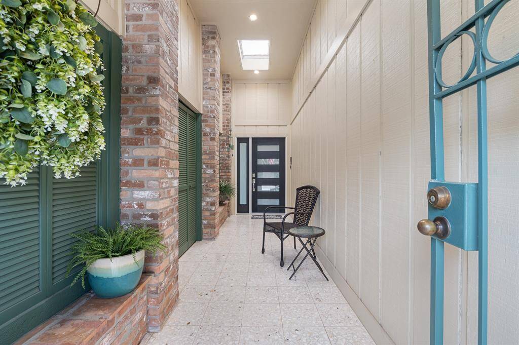 A charming gated front walkway offers both privacy and curb appeal, guiding you toward the a garage entrance and front door. This thoughtful layout combines convenience with a warm, welcoming feel.