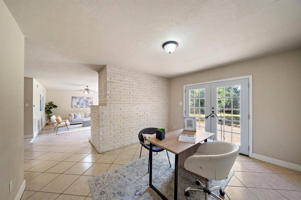 Perfect as a home office, play room or quiet seating area, with French door access to the backyard.