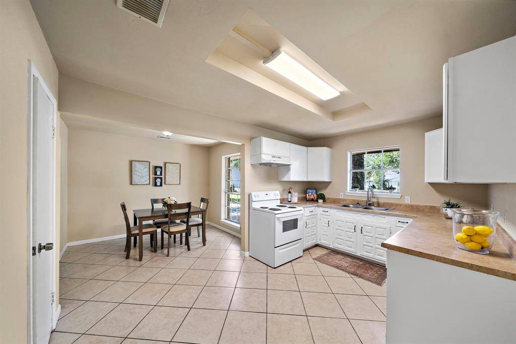 The kitchen with two pantries and a little window looking out to the front yard.