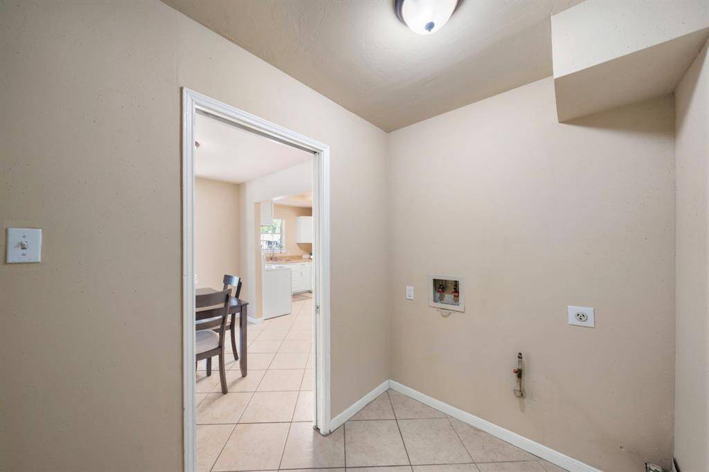 Enter the garage into the utility room, half bath to the right and entry to the home to the left.