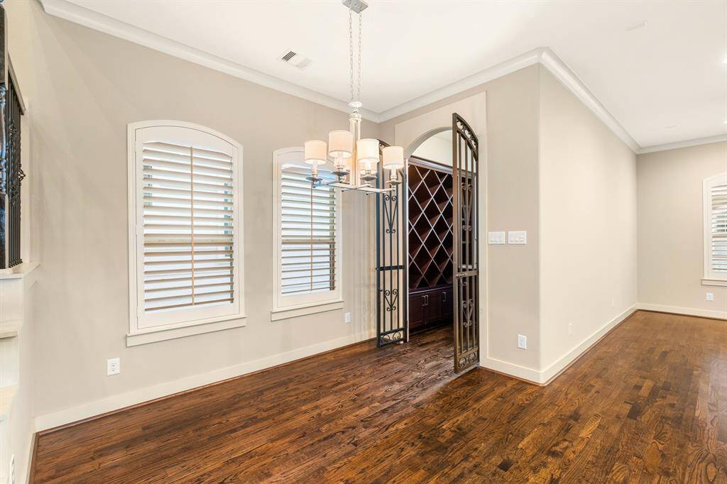 Breakfast table area as well as wine cellar entrance with grand metal doors.