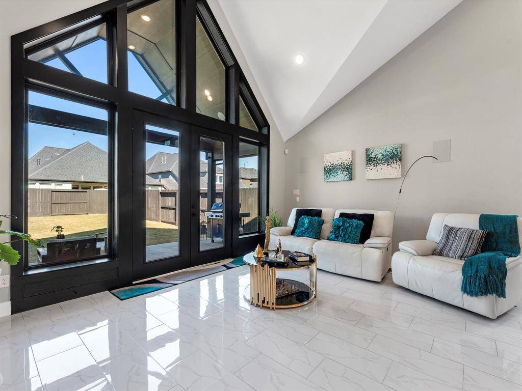 The layout, with beautiful windows, vaulted point ceiling and warm tones encase a great family area with the open   view of  extended patio an huge backyard for pleasure and entertaining