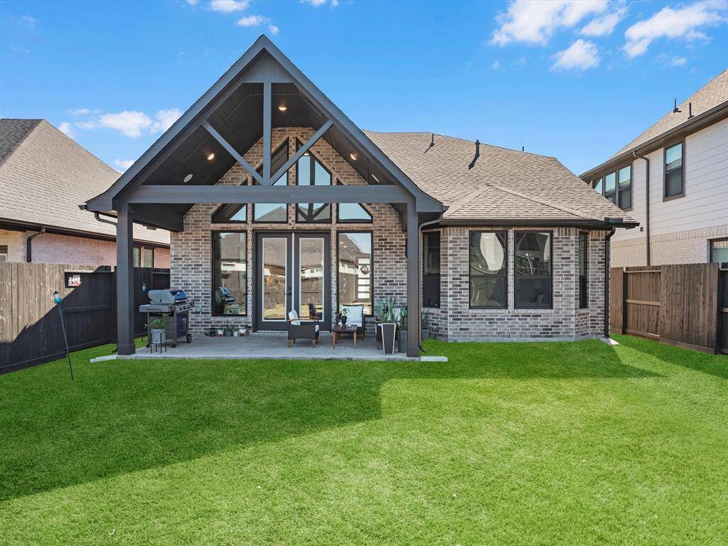 This inviting outdoor space offers a perfect retreat for relaxation and entertaining. sowing the magnificent arquitectural pointed vaulted ceilings of this house an all brick in the back with element of stucco and stone at the front another upgrade on this house!
